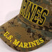 marines embroidered black letter in yellow outline on green camo hat with marines on brim