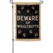 Garden flag with 'Beware of Wigglebutts' text and paw prints on a wooden looking background