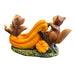 Decorative figurine of two foxes on a pumpkin slide