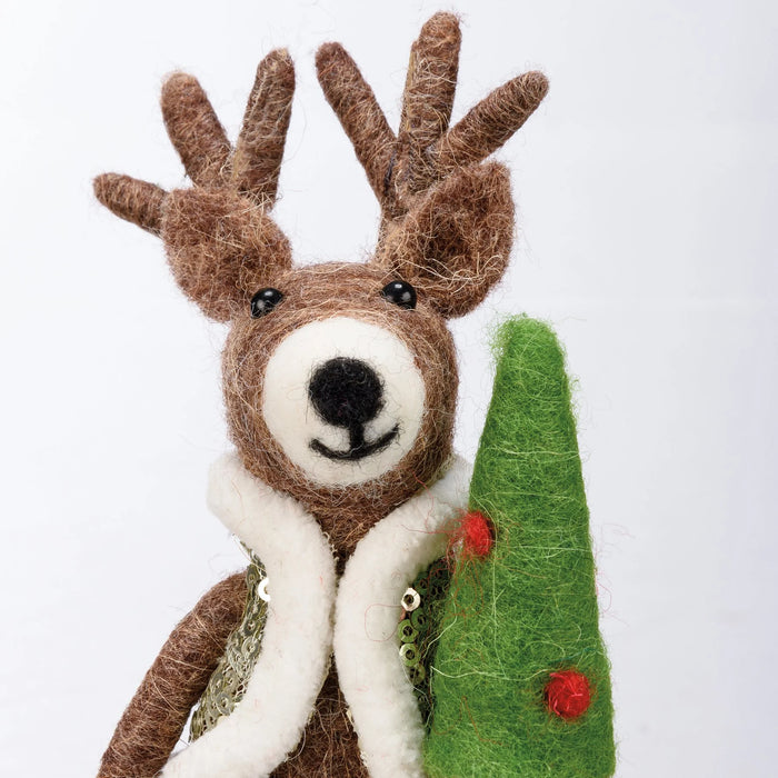 felted reindeer ornament wearing a vest holding a Christmas tree with red ornaments