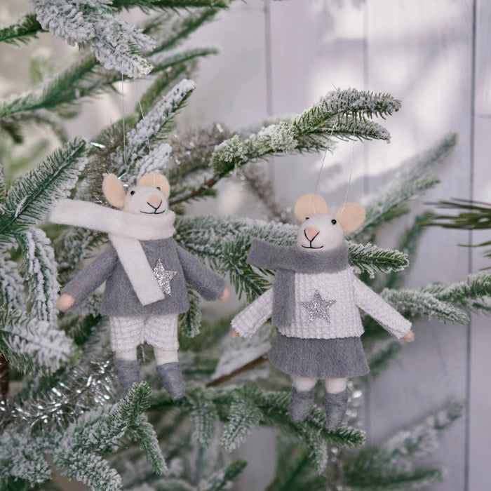 Two felted mouse ornaments wearing sweaters and scarves with a star designed shirt