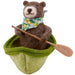 felted bear in a green boat with a paddle on a white background