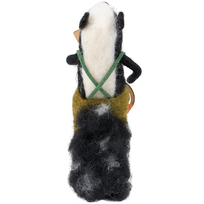 Felted skunk playing a banjo figurine that stands on a table