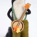Felted skunk playing a banjo figurine that stands on a table