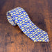 silk necktie with a blue background and repeated butter lamb pattern