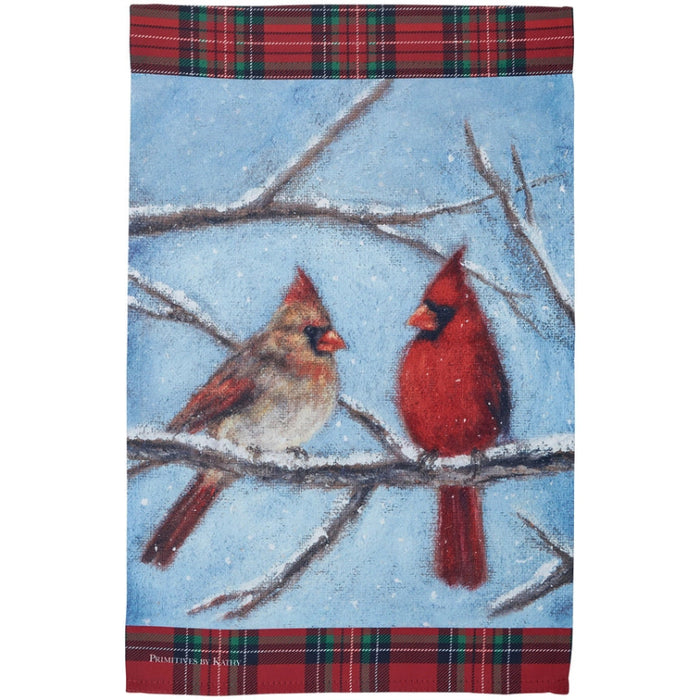 Garden flag with two cardinals on a branch against a blue sky background and snow