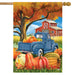 Decorative flag with a blue truck, pumpkins, and barn scene on an autumn background.