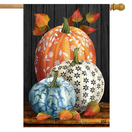 Decorative flag with pumpkins and leaves on a wooden look background