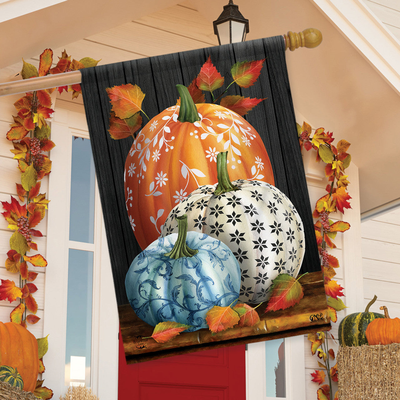 Decorative flag with pumpkins and leaves on a wooden look background