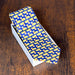 silk necktie with a blue background and repeated butter lamb pattern