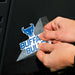 Person applying a 'Buffalo Bulls' decal to a black surface
