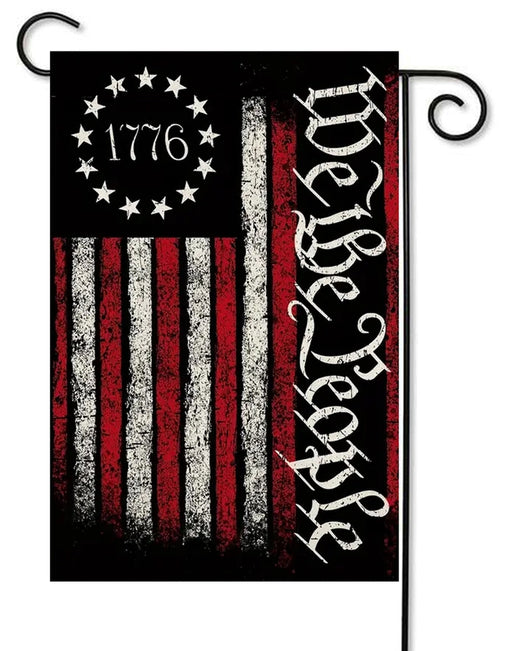 American flag with 'We the People' text and '1776' design on a black background