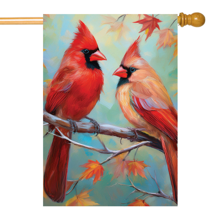 Decorative flag with two red cardinals on a branch against a colorful background with fall leaves
