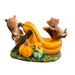 Decorative figurine of two foxes on a pumpkin slide