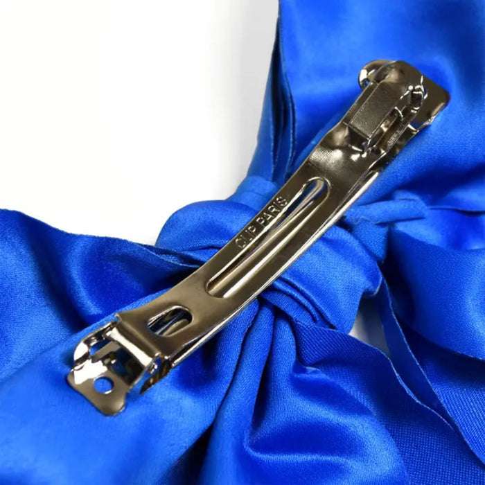 Blue hair bow with scattered Buffalo Bills logos and clip on the back side to secure to hair