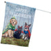 Decorative Halloween flag with dogs and a cat in costumes against a blue background.