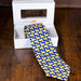 silk necktie with a blue background and repeated butter lamb pattern
