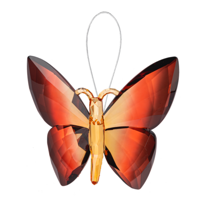 Butterfly-shaped ornament with orange and red gradient wings on a white background