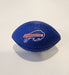 A small blue textured football-shaped object with the Buffalo Bills charging buffalo logo in white and red, placed on a light gray surface.