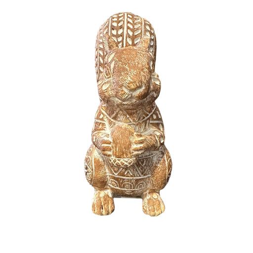 Decorative squirrel figurine with intricate floral-like patterns on a white background