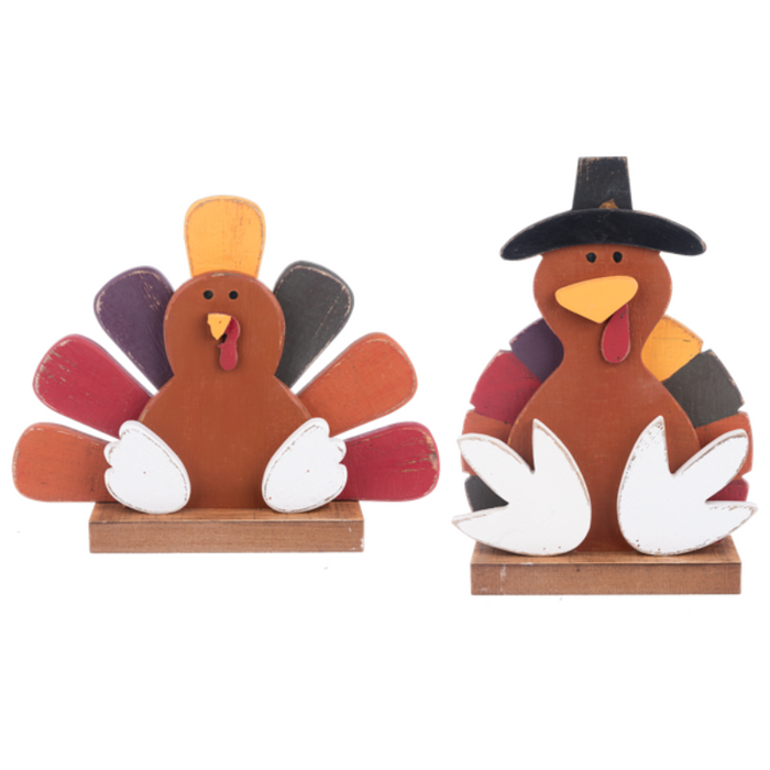 Two decorative turkey figurines on wooden bases with a white background