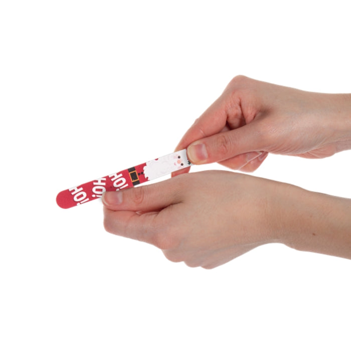 hand showing the use of a Christmas themed nail file