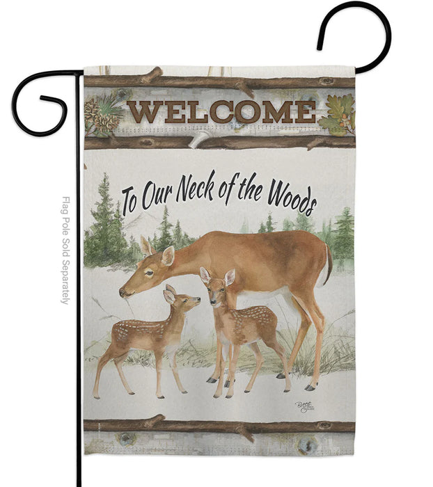 Decorative flag with deer family and 'Welcome to Our Neck of the Woods' text on a pine themed background.