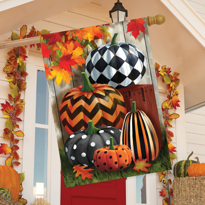 Decorative flag with pumpkins and autumn leaves on a wooden look background