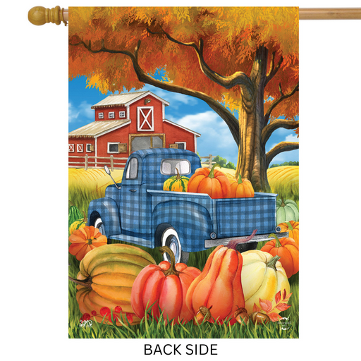 Decorative flag with a blue truck, pumpkins, and barn scene on an autumn background.