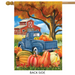 Decorative flag with a blue truck, pumpkins, and barn scene on an autumn background.