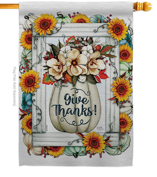 Decorative flag with 'Give Thanks!' text in a pumpkin vase surrounded by flowers and sunflowers.