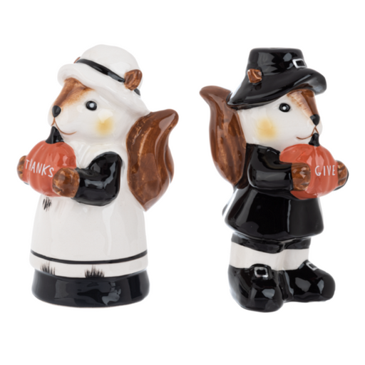 Two ceramic squirrel salt and pepper shakers, one in a pilgrim outfit and the other in a maid outfit, holding pumpkins that say "Give" "Thanks".