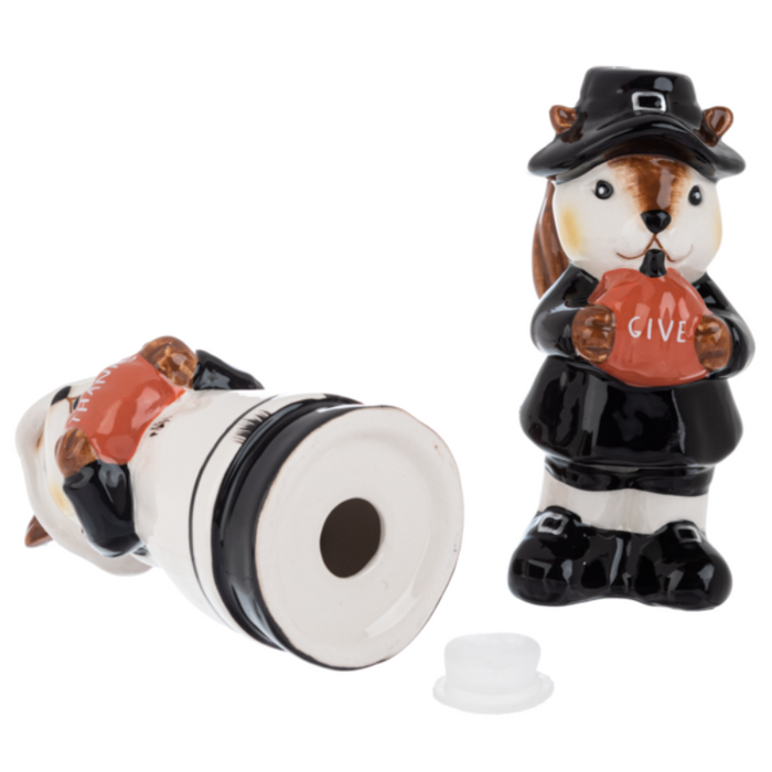 Two ceramic squirrel salt and pepper shakers, one in a pilgrim outfit and the other in a maid outfit, holding pumpkins that say "Give" "Thanks".