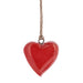 Red heart-shaped ornament hanging on a string against a white background