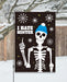 Skeleton wearing a blue beanie with 'I Hate Winter' text on a decorative flag.