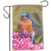 Garden flag with a bluebird and pink flowers on a green background