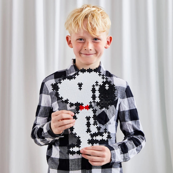 Peanuts-themed puzzle featuring a Snoopy logo made out of building blocks
