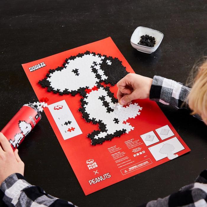 Peanuts-themed puzzle featuring a Snoopy logo made out of building blocks
