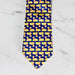 silk necktie with a blue background and repeated butter lamb pattern