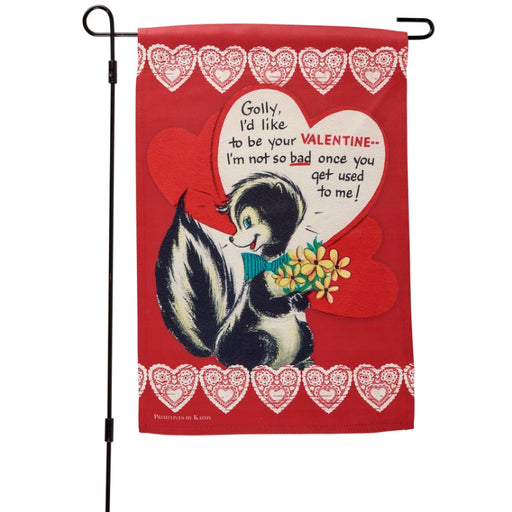 Valentine's Day-themed garden flag with cartoon skunk holding flowers and text on a red background with heart designs.