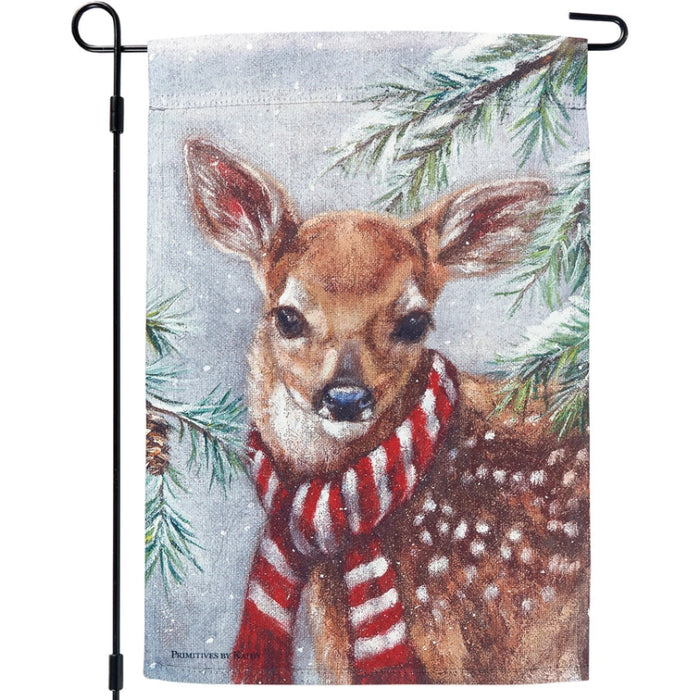 Garden flag with a deer wearing a red and white striped scarf against a snowy background with pine trees