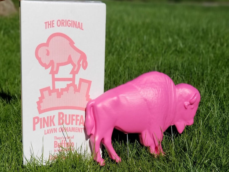PINK BUFFALO LAWN ORNAMENT NEXT TO PACKAGE IN THE GRASS