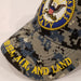 navy seal embroidered on blue camo hat with by sea air and land on brim