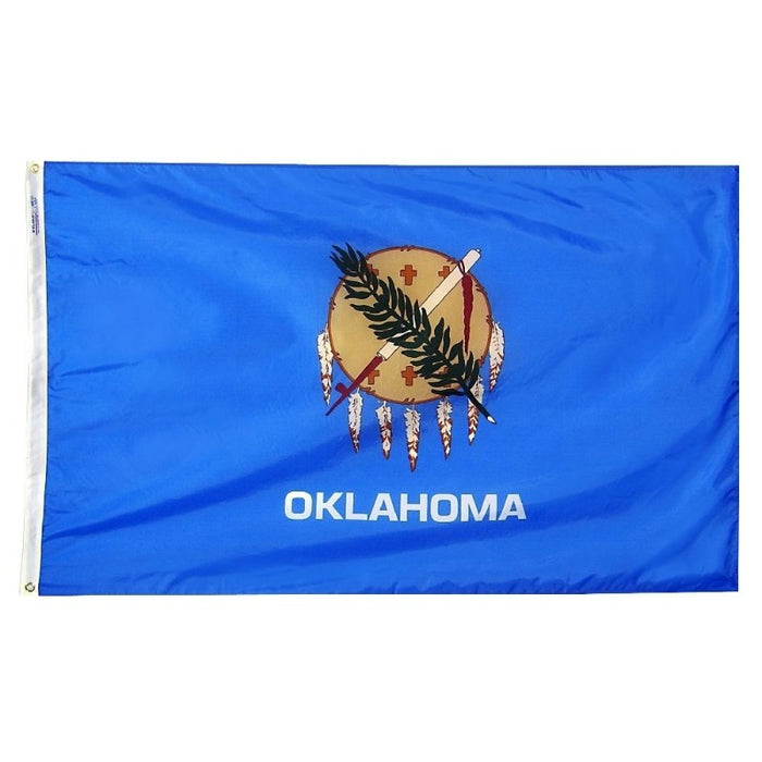 blue flag with a shield, olive branch, and peace pipe logo with the word "Oklahoma"