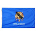 blue flag with a shield, olive branch, and peace pipe logo with the word "Oklahoma"