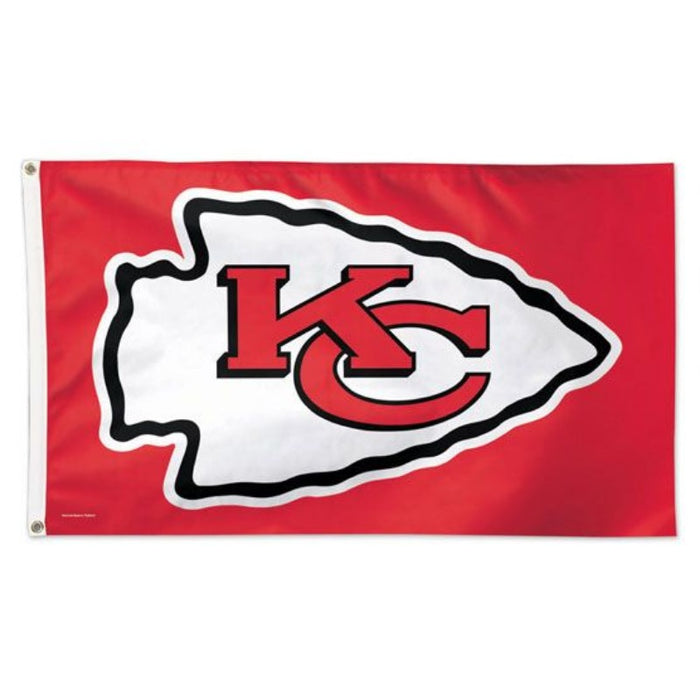 red flag with a white arrow head logo and a KC in the center