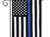 black and white american flag with a single blue stripe down the center on a garden stand
