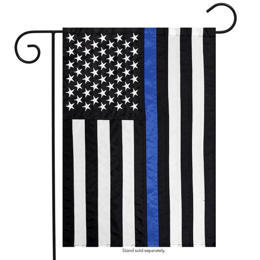 black and white american flag with a single blue stripe down the center on a garden stand