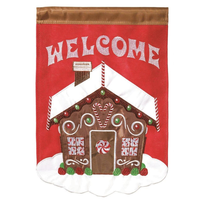 gingerbread house flag with the word welcome at the top