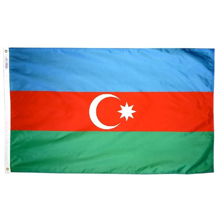 blue red and green horizontally striped flag with a white moon and star in the center